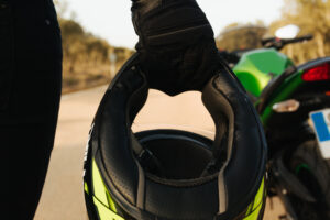 motorcyclist holding helmet