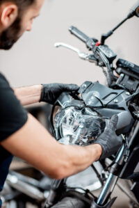 man observing motorcycle damage