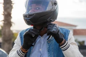 man putting on motorcycle helmet