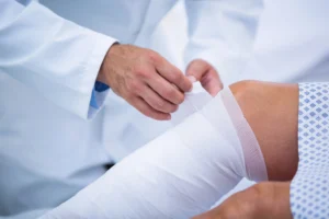 doctor bandaging road rash injury from motorcycle accident